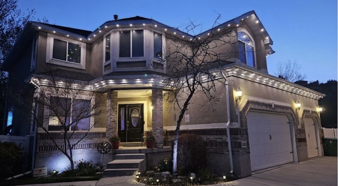 Warm white permanent lights around a two-story home