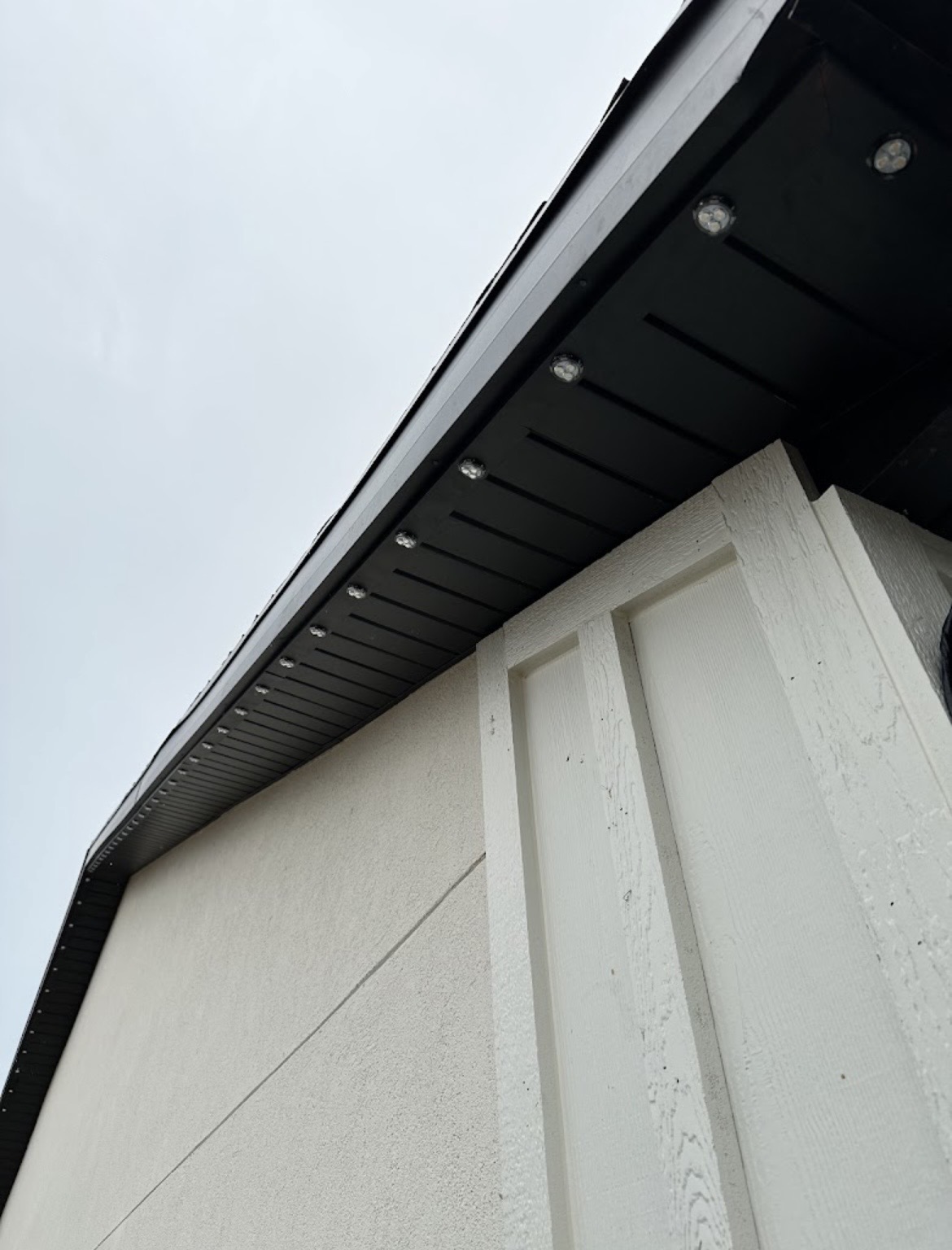 Close view of permanent lights mounted under dark soffit