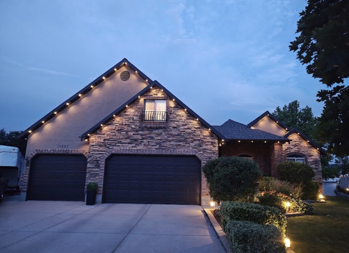 Warm white lights on a stone front home