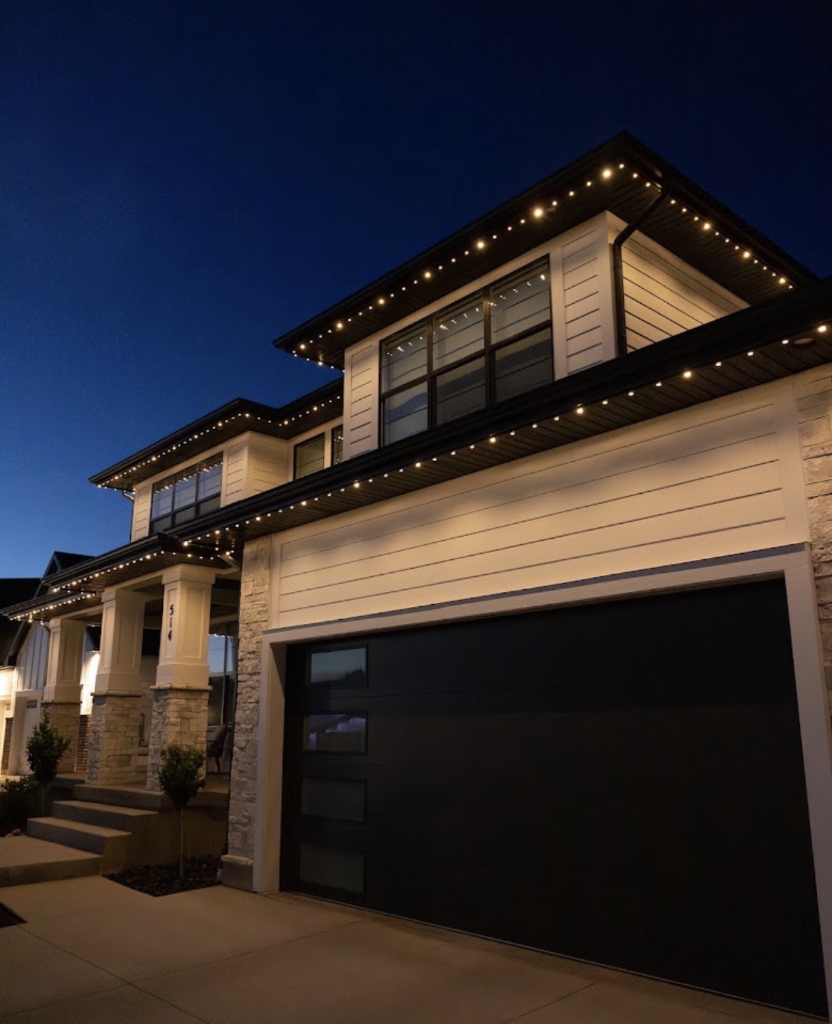 Warm white permanent lighting on a modern home