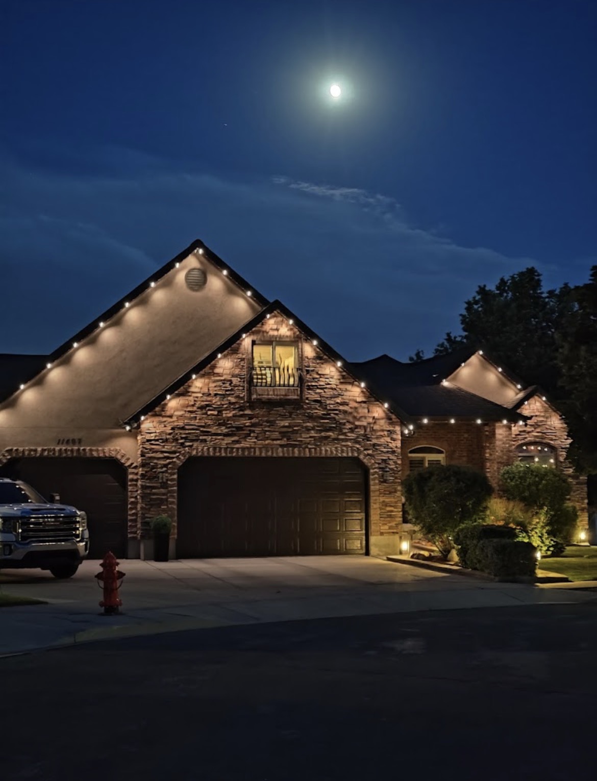 Warm white permanent lights outlining a residential roofline