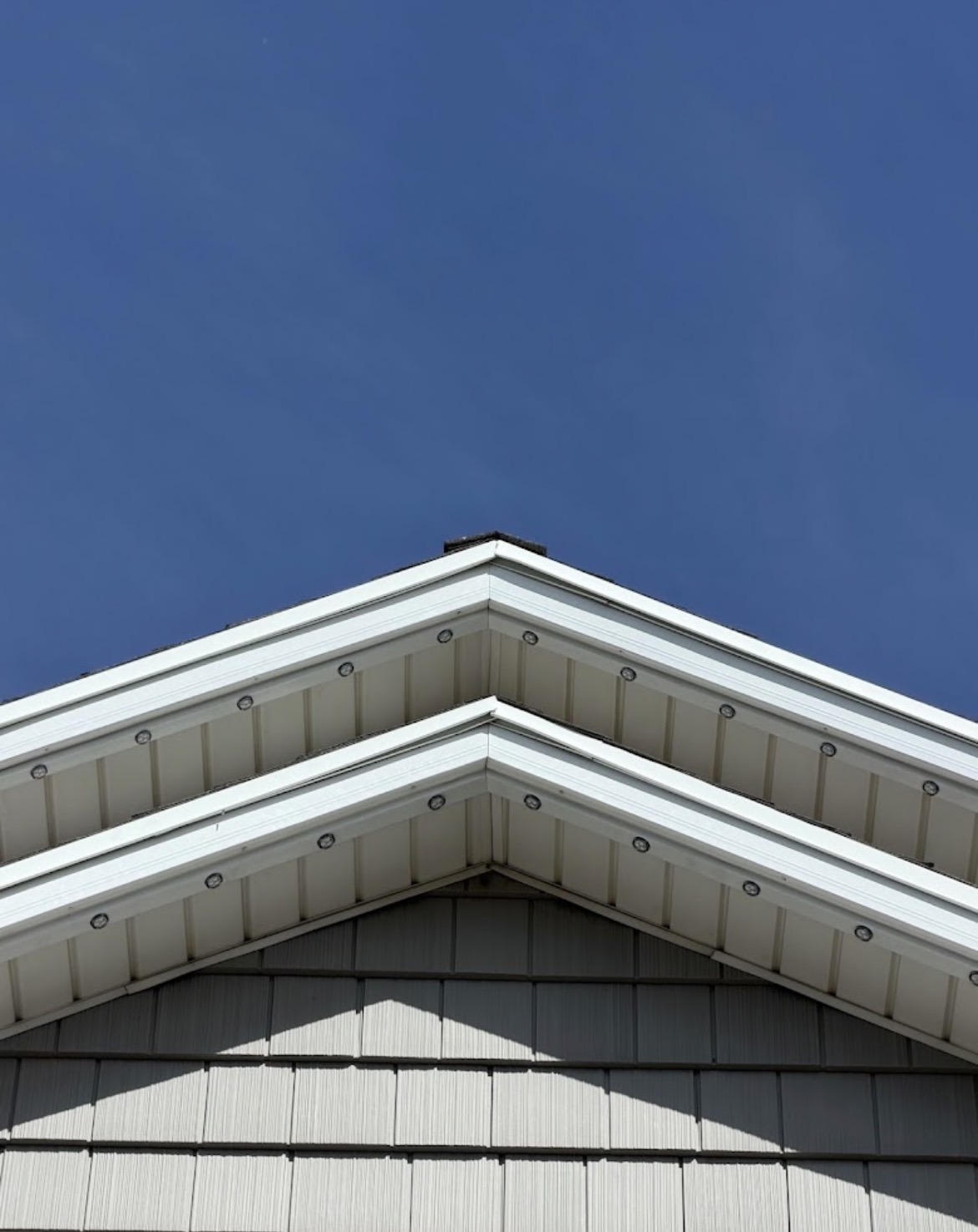 Close view of permanent light pods under a soffit